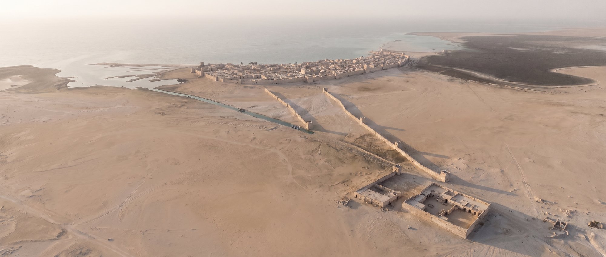 Al Zubarah seen from inland: the fort, the twin walls and the channel running towards the town on the coast